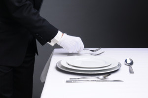 Waiter Setting Formal Dinner Table